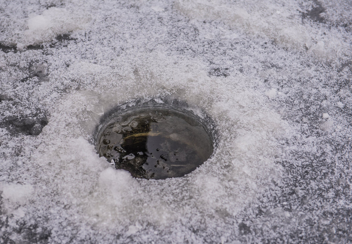 Ice angler using Cortland Master Braid for winter fishing success