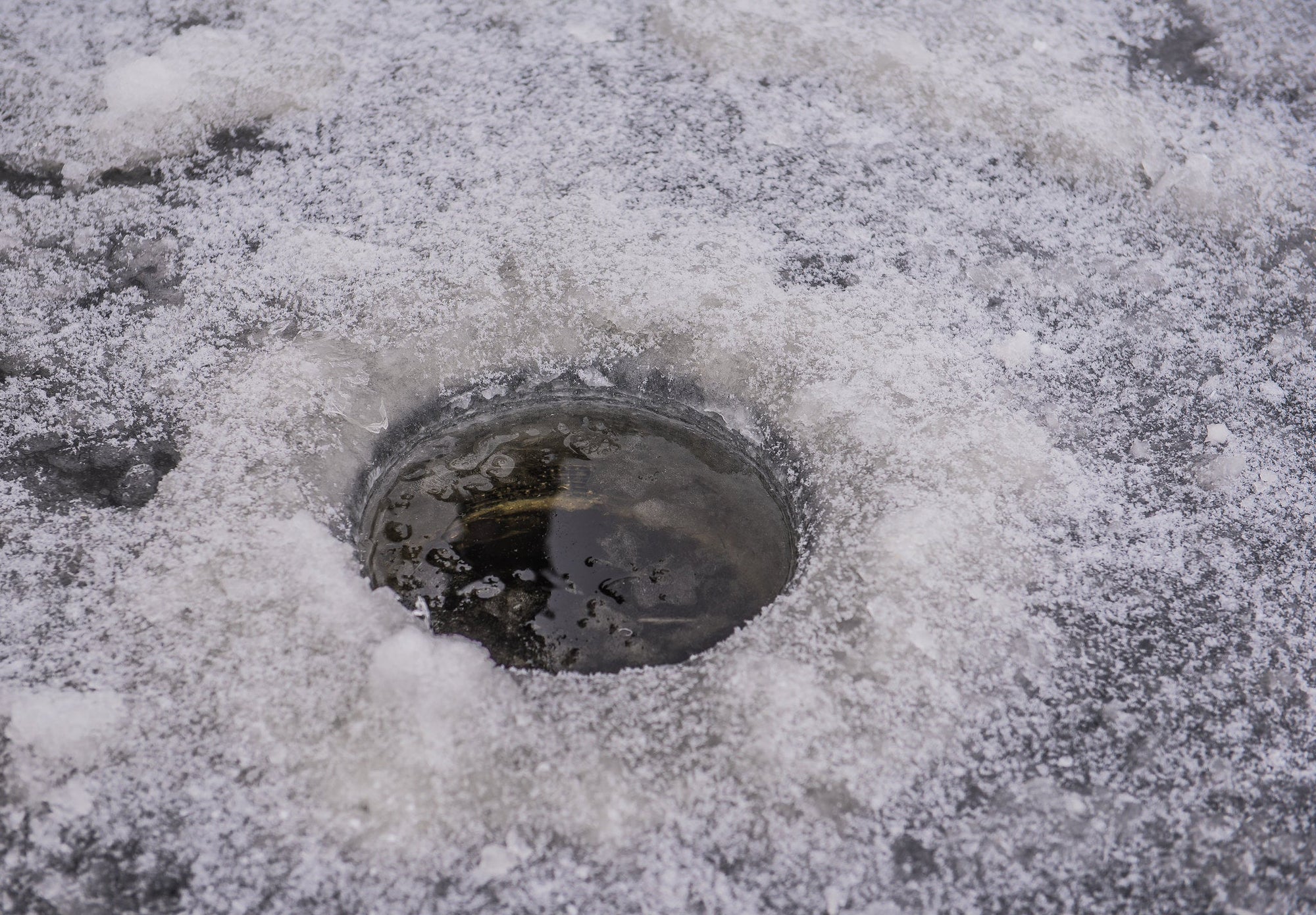 Ice angler using Cortland Master Braid for winter fishing success