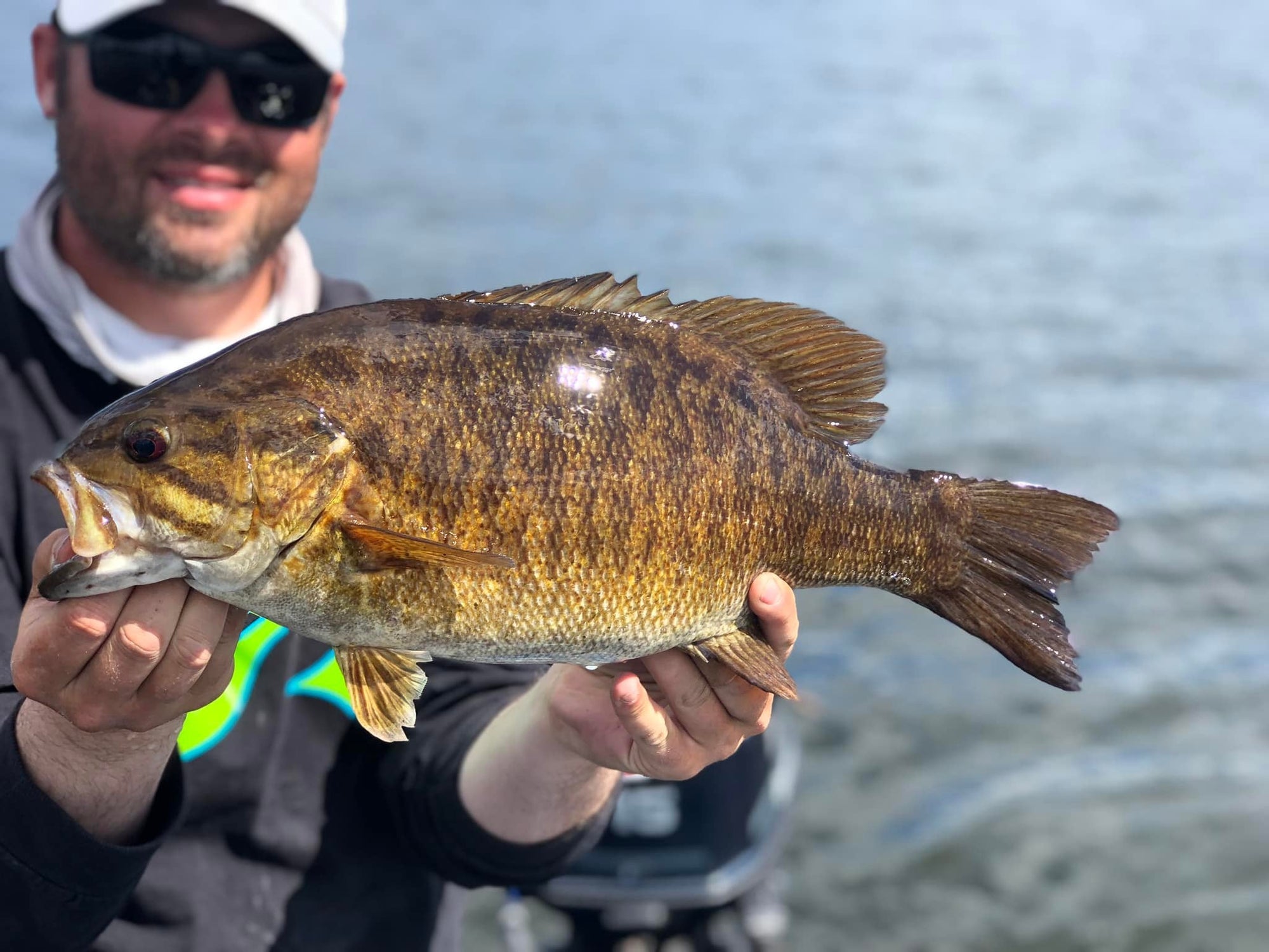 Angler presenting finesse bait to smallmouth bass using long rod and light line technique