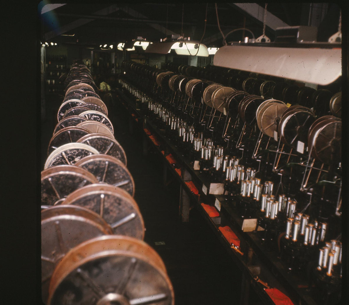 Row of large mechanical reels in a dark room